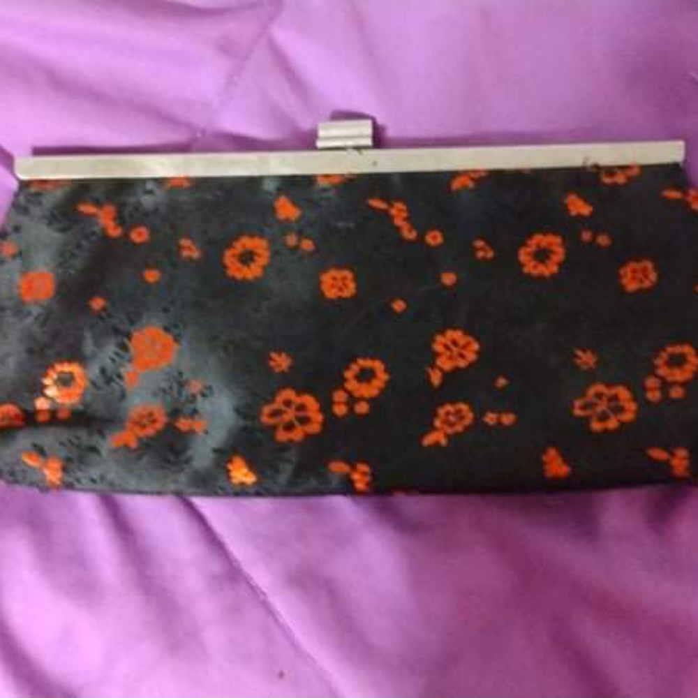 Black handbag with red flower print